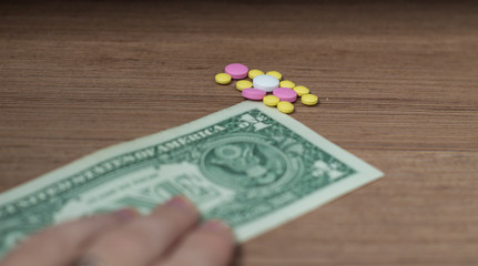 Canvas Print - A dollar and a stack of coins on the table