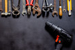 Tools for repair and reconstruction in home conditions lie on a black background