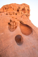 Face Carved In Red Sandstone Rock From Years Of Wind Erosion By Sand At The Valley Of Fire State Park In Nevada.
