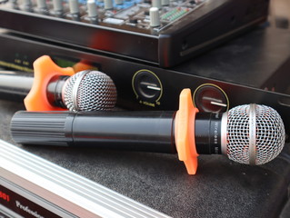 Close-up of two wireless microphones.