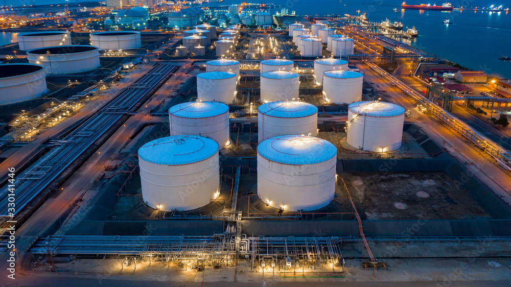 Aerial view oil and gas terminal storage tank farm,Tank farm storage chemical petroleum petrochemical refinery product, Business commercial trade fuel and energy transport by tanker vessel. - obrazy, fototapety, plakaty 