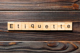 Fototapeta  - ETIQUETTE word written on wood block. ETIQUETTE text on wooden table for your desing, concept