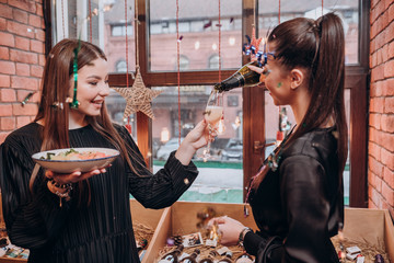 two young girls in black dresses have fun in a restaurant