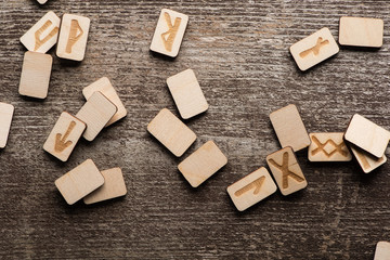 Top view of shamanic runes with symbols on wooden surface