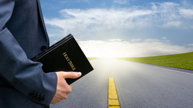 man holding bible in his hand. Concept for faith, spirituality and religion.