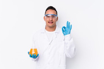 Young latin cientific man isolated  cheerful and confident showing ok gesture.