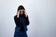© Sergio Barceló - Portrait of attractive caucasian middle age woman keeps hand on head, grimaced, has problems, being in bad mood, has terrible headache, isolated on gray background studio shot, black sweater, denim ja