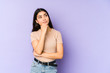 © Asier - Young indian woman isolated on purple background relaxed thinking about something looking at a copy space.