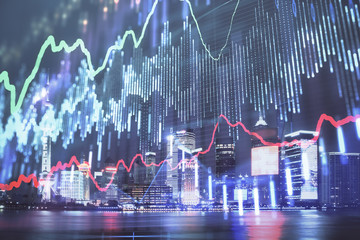 Financial graph on night city scape with tall buildings background double exposure. Analysis concept.