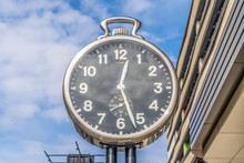 Large Stop Watch Shape Street Clock On An American Street With Blue Sky Background