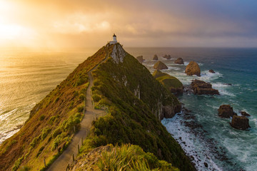 Canvas Print - Nugget Point and lighthouse with sunrise at South Island, New Zealand