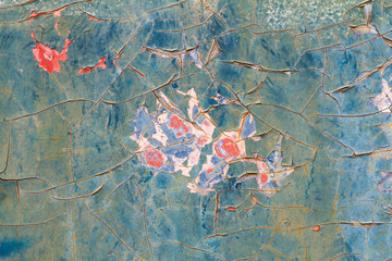 Wall Mural - Old paint cracks on steel wall texture background. Cracked wall with old layers of paint.