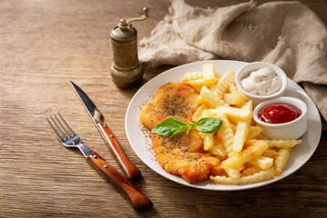 Wall Mural - plate of chicken schnitzel and french fries