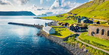 View From Flying Drone. Aerial Summer View Of Kirkjubour Villagewith Hestur Island On Background. Picturesque Morning Scene Of Faroe Islands, Denmark, Europe.  Beauty Of Nature Concept Background.