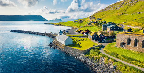 Wall Mural - view from flying drone. aerial summer view of kirkjubour villagewith hestur island on background. pi