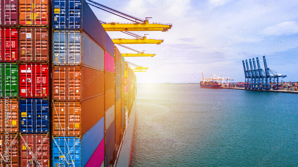 Container ship carrying container box in import export with quay crane ...