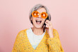happy young style elderly grandma with orange sunglasses and modern looking laughing on the phone