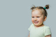 © kaloriya - Portrait of smiling baby toddler on gray background. Happy childhood. Free space for text.