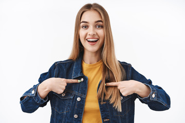 Hopeful and excited blond female student pointing at herself and smiling broadly wishing to participate, want become candidate, talking about personal achievement, volunteer, white background