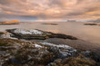 An early morning seascape photographed at sunrise in the small fishing village of Sommaroy, Norway.