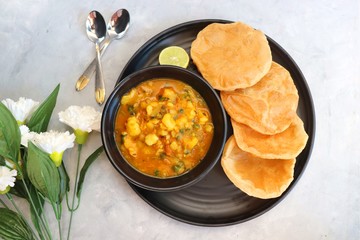 Wall Mural - Indian cuisine - Puri Bhaji. It is a traditional breakfast dish in North India. Puri is a deep fried bread made from whole wheat flour & Served with spicy Potato curry called bhaji or alu ki sabji. 