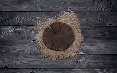 Wall Mural - Round cutting board on black wooden table