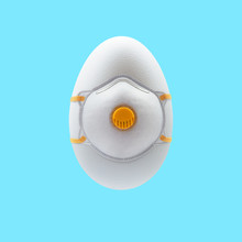 White Easter Egg With A Protective Face Mask Against A Blue Background