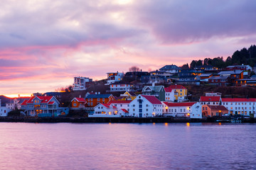 Wall Mural - View of city center of Kristiansund, Norway during the cloudy morning at sunrise with colorful sky