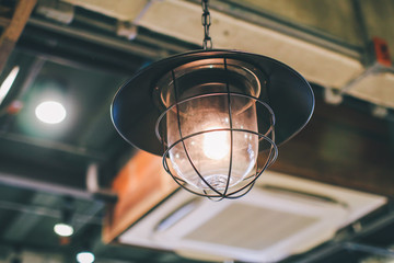 Retro lighting decor in coffee shop.Hang ceiling lamp for interior design and decoration. Image idea for thinking concept.