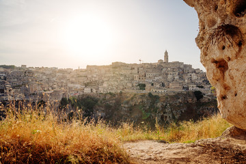 Poster - Admiring sunset from a grotto cave on Sassi di Matera, Basilicata, Italy.