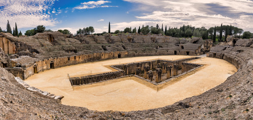 Wall Mural - Panoramic view of the Roman amphitheater of Italica, now a major tourist attraction in Santiponce, Spain.