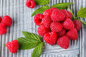 juicy fresh natural raspberries on a gray wooden rustic background