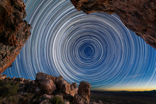 A Beautiful Night Sky Photograph With Circular Star Trails Framed By Dramatic Rocks In The Foreground, Taken In The Cederberg Mountains In The Western Cape, South Africa.