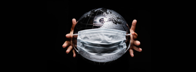 Wall Mural - kid holding globe map sphere isolated on black horizontal background. ecological problems disasters.