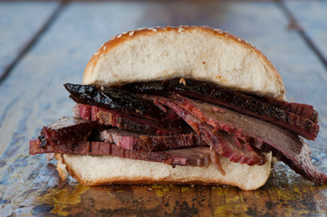 Wall Mural - BBQ Sandwiches. Classic Traditional Texas barbecue sandwiches. Slow roasted pulled pork. Thick sliced smoked beef brisket. Chopped beef brisket with secret sauce bbq sauce. Served on white buns.