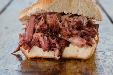 Wall Mural - BBQ Sandwiches. Classic Traditional Texas barbecue sandwiches. Slow roasted pulled pork. Thick sliced smoked beef brisket. Chopped beef brisket with secret sauce bbq sauce. Served on white buns.