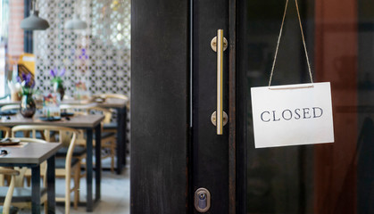  closed sign hanging outside a restaurant, store, office or other