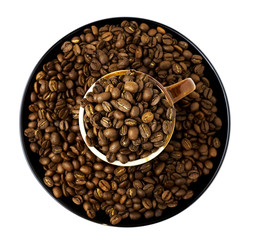 cup full of coffee beans and a plate with coffee beans isolated on white. Top view