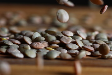 Sticker - lentil grains scattered on a wooden surface