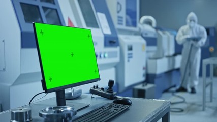 Leinwandbilder - Factory Cleanroom: On the Desk Personal Computer Showing Green Screen Chroma Key Display. In Background CNC Machinery, Professionals Use Robot Arm on Production Line. Zoom in Shot