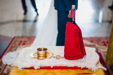 Bride and groom at the church during a wedding ceremony. Priest putting on golden wedding ring on bride finger. Wedding matrimony in church. Exchanging rings and vows