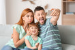© Pixel-Shot - Family taking selfie at home