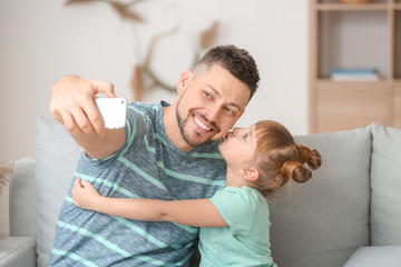 Poster - Father and his little daughter taking selfie at home