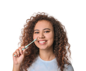 Wall Mural - Young woman with toothbrush on color background