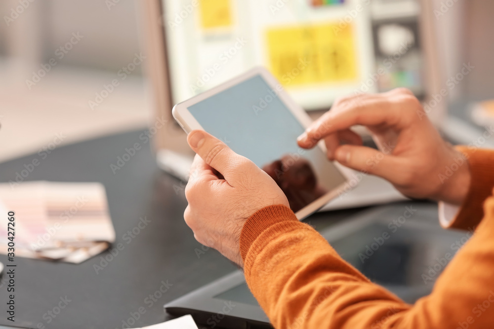 Male IT designer working in office, closeup
