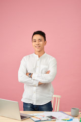 Portrait of confident Asian man  standing with his arms folded and looking at camera