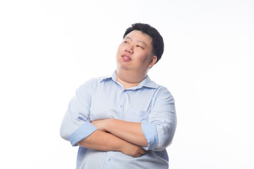 Wall Mural - Asian Fat Man in blue shirt arm crossed and looking to copyspace with happy face isolated on white background.