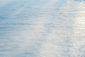 Background from a flat ice surface sprinkled with light snow