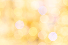 Gold Bokeh Background. Abstract Glitter Festive Blur Lights. Soft Yellow Christmas Backdrop.