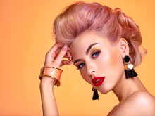 Beautiful Woman With Creative Hairstyle, Vivid Makeup. Fashionable Girl. Beautiful Face Of Young Woman With Red Lips. Stunning Blonde Girl. Bright Eye Makeup. Attractive Caucasian Model With Earrings
